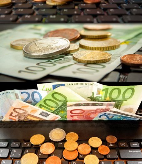 Евро валюта рассыпана по ноутбуку - растровые картинки